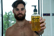 mens body wash man holding it straight out